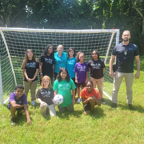 Students Playing Soccer with Coach